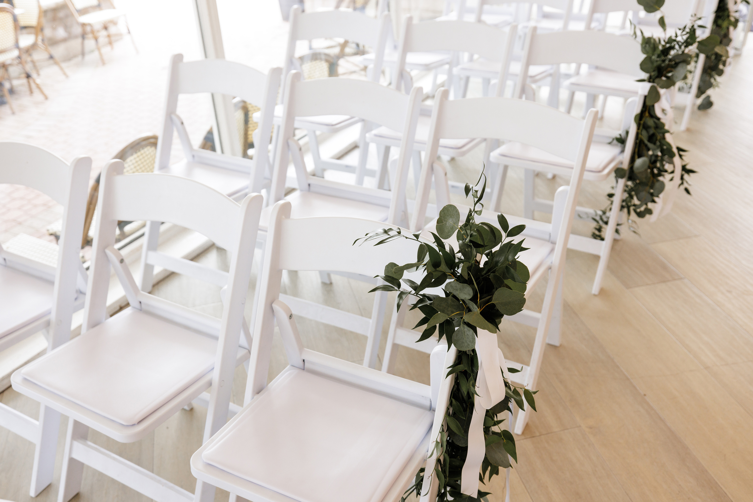 white folding chairs wedding ceremony gate house indoor venue