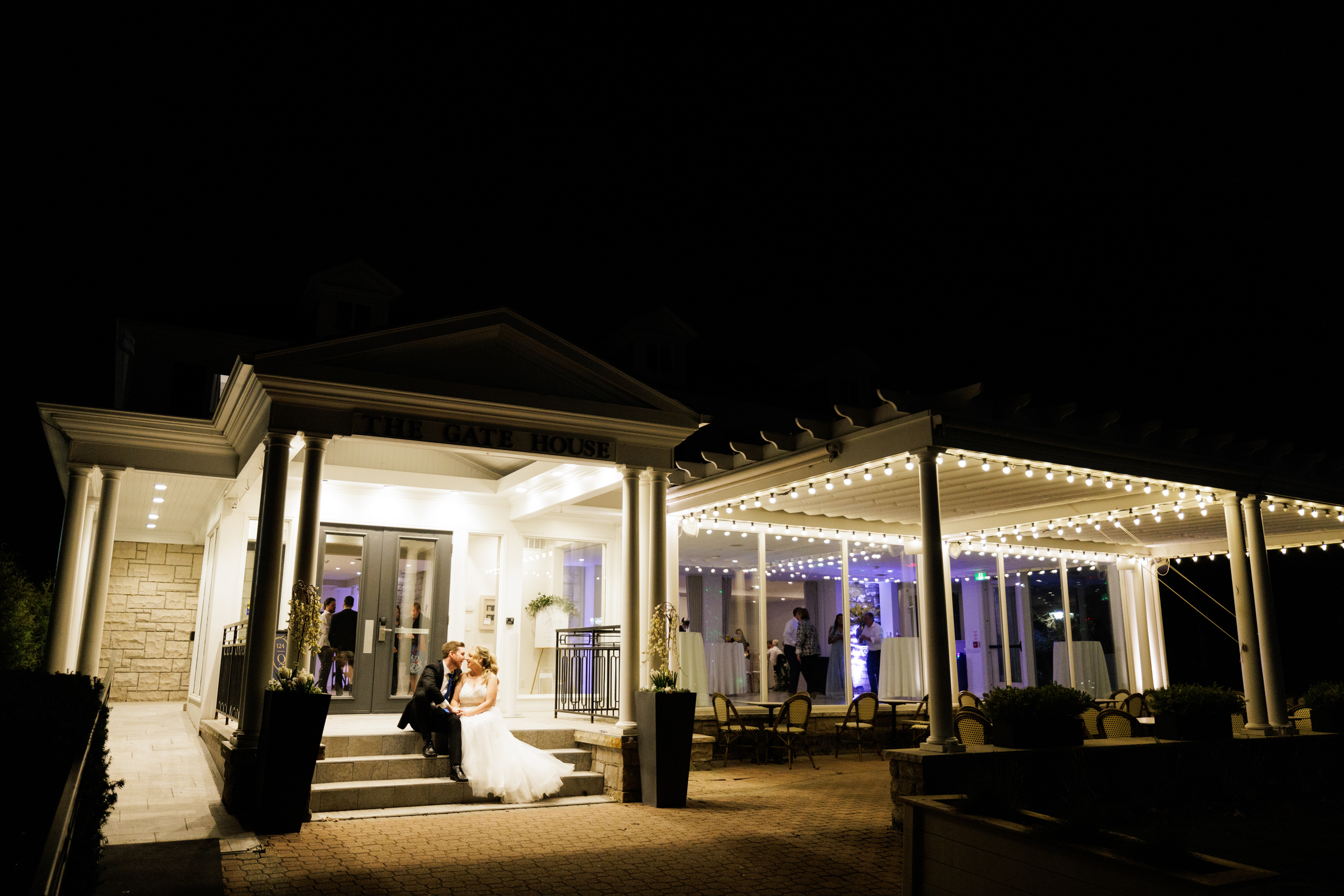 bride groom on steps of gate house at night