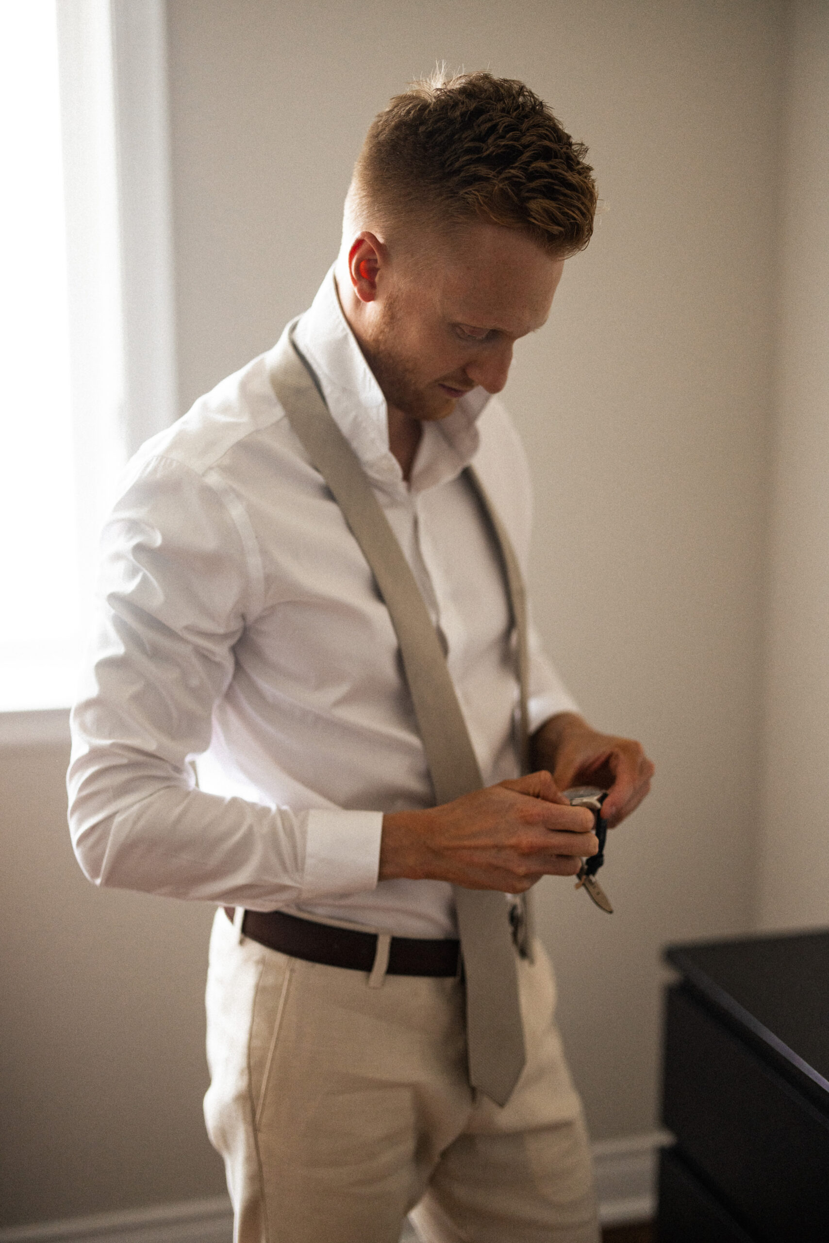 groom getting ready wedding day afterglow