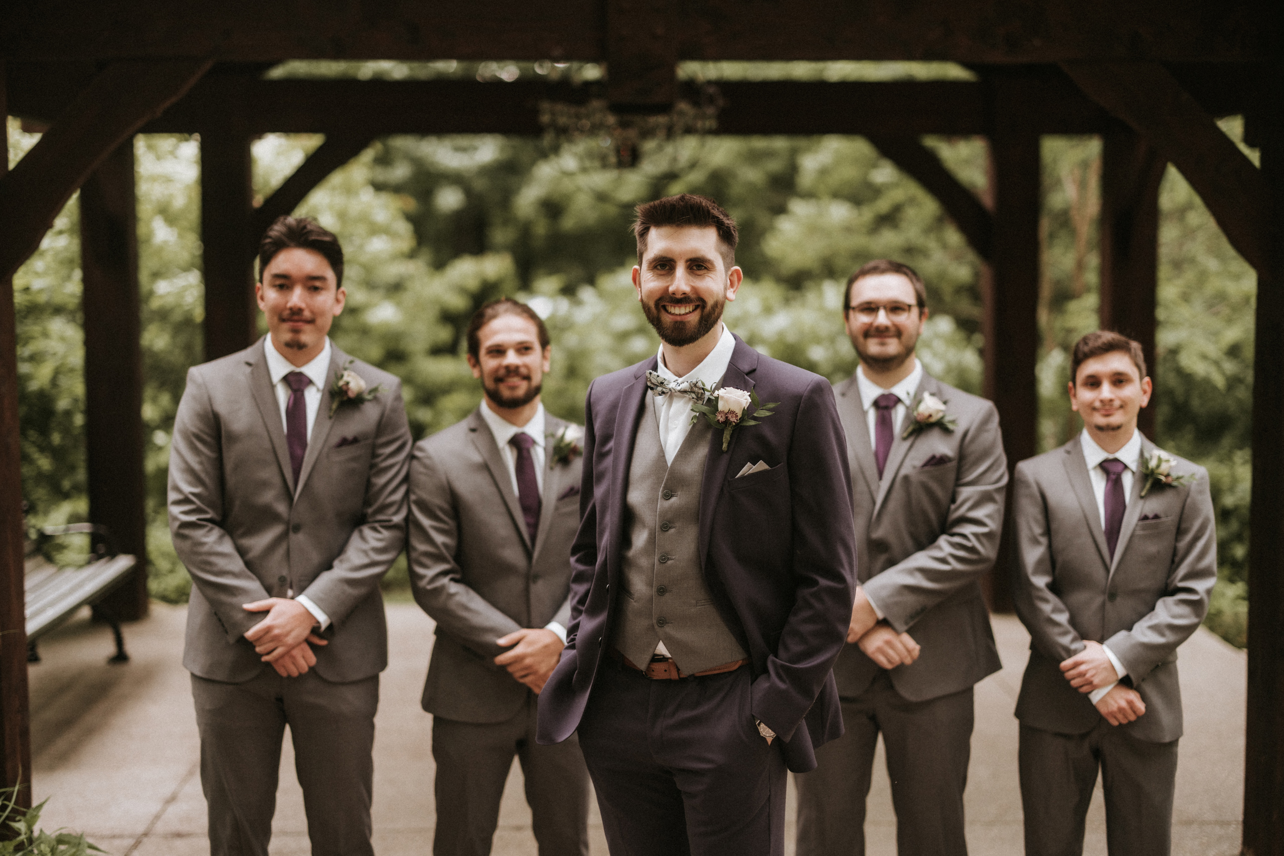 groomsmen walking bridge ancaster mill summer wedding