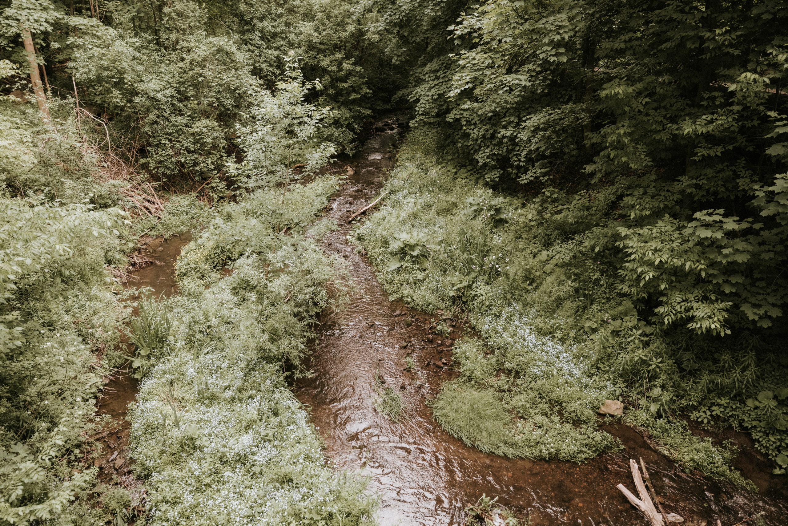 groomsmen walking bridge ancaster mill summer wedding