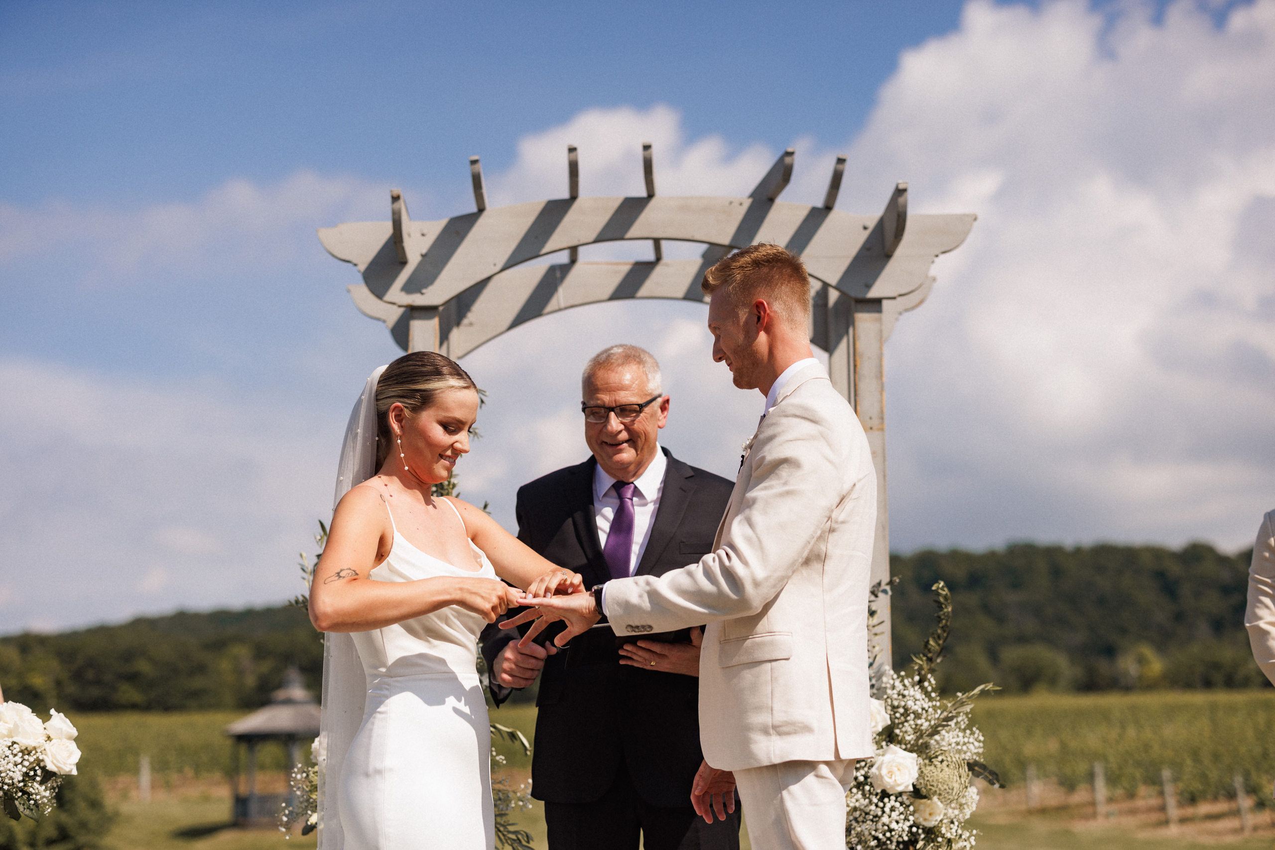 ring exchange outdoor ceremony cave spring vineyard summer weddi