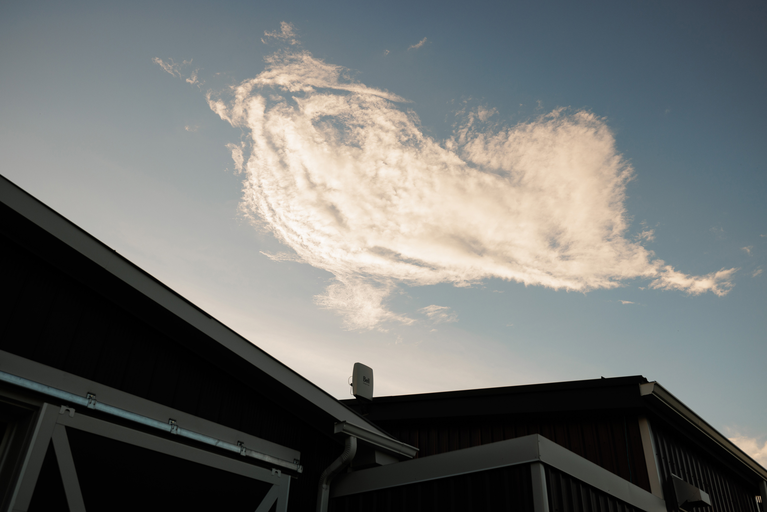 interesting clouds over barn