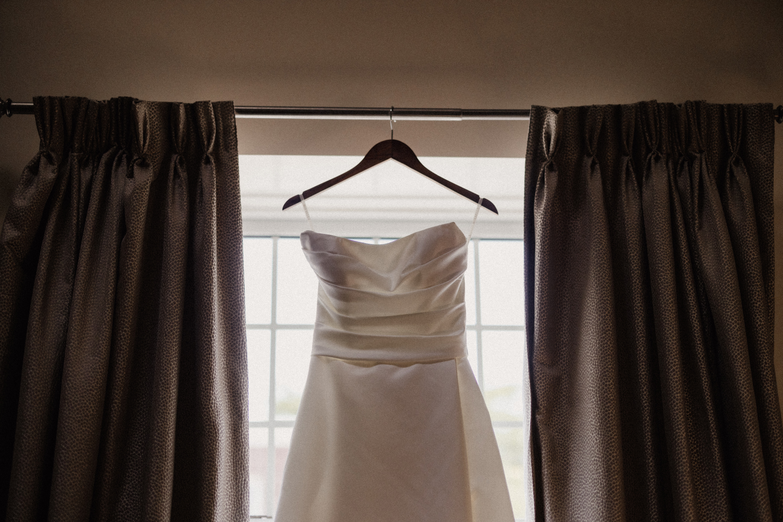 bride gown hanging in window