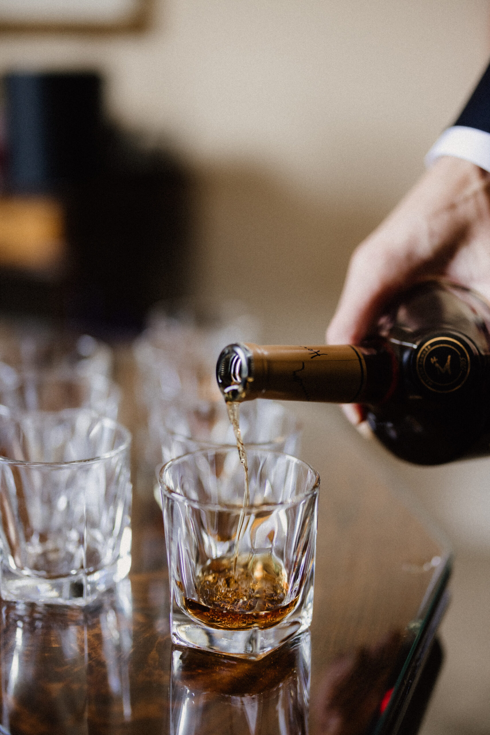 groom pouring cognac wedding inn on the twenty