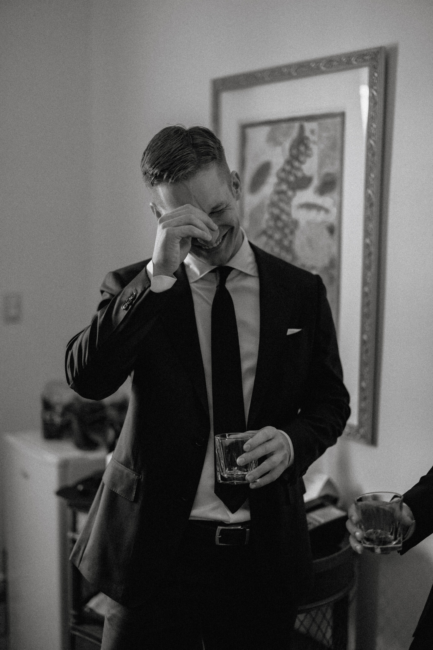 black white film groom getting ready inn on the twenty