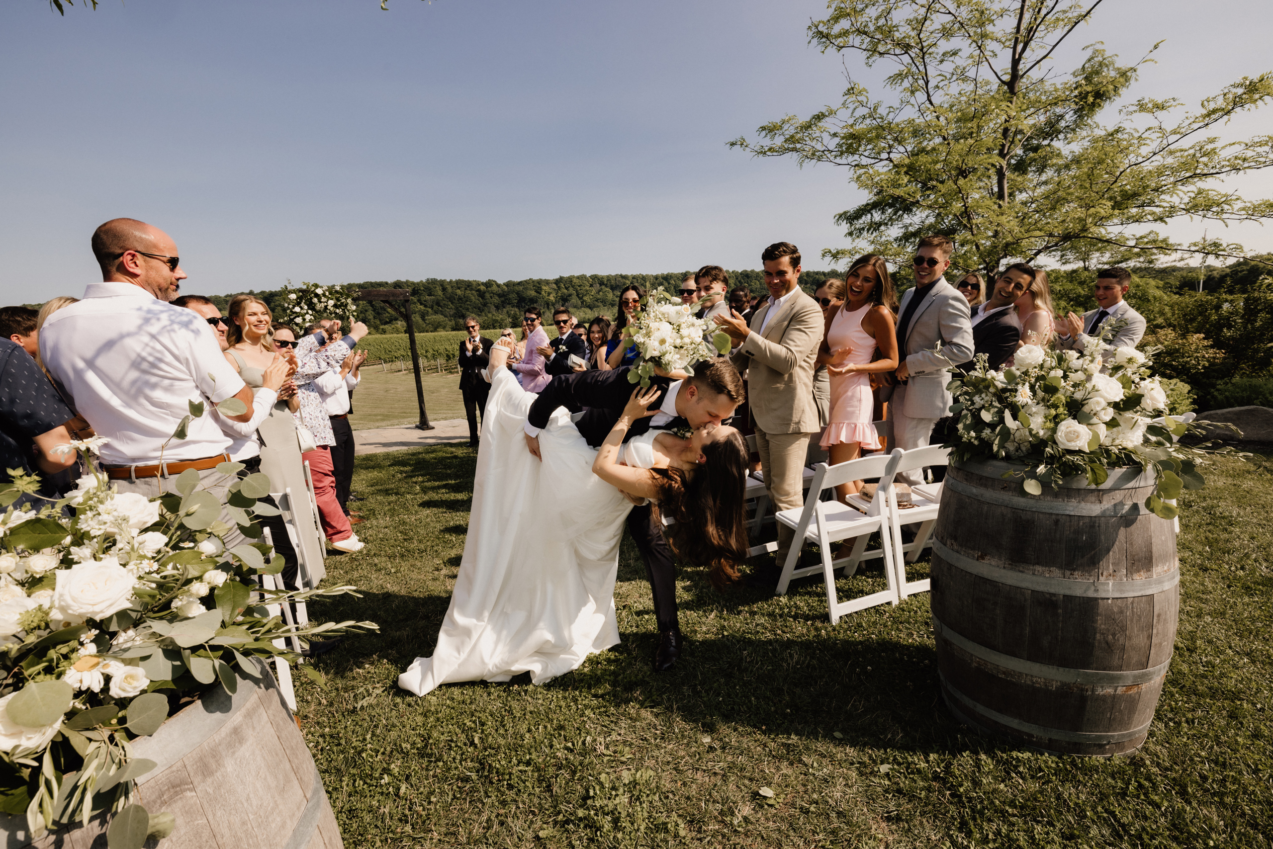 groom dips bride exit aisle ceremony wedding