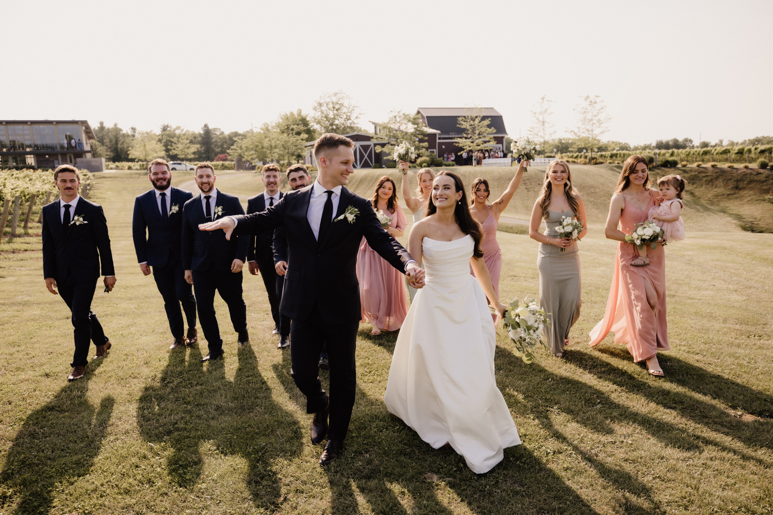 wedding party walk through field cave spring barns