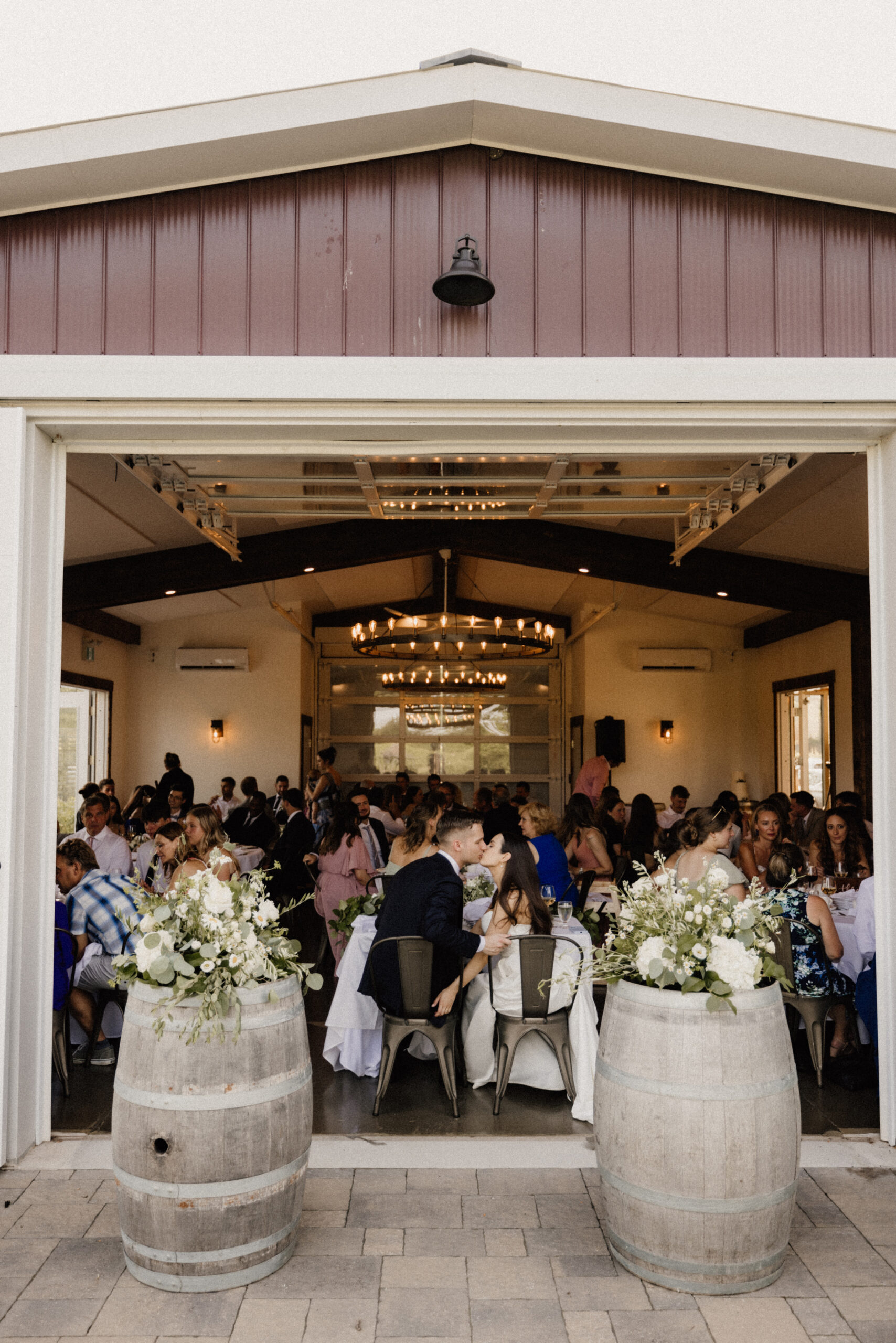 bride groom kiss wedding reception barn cave spring photography