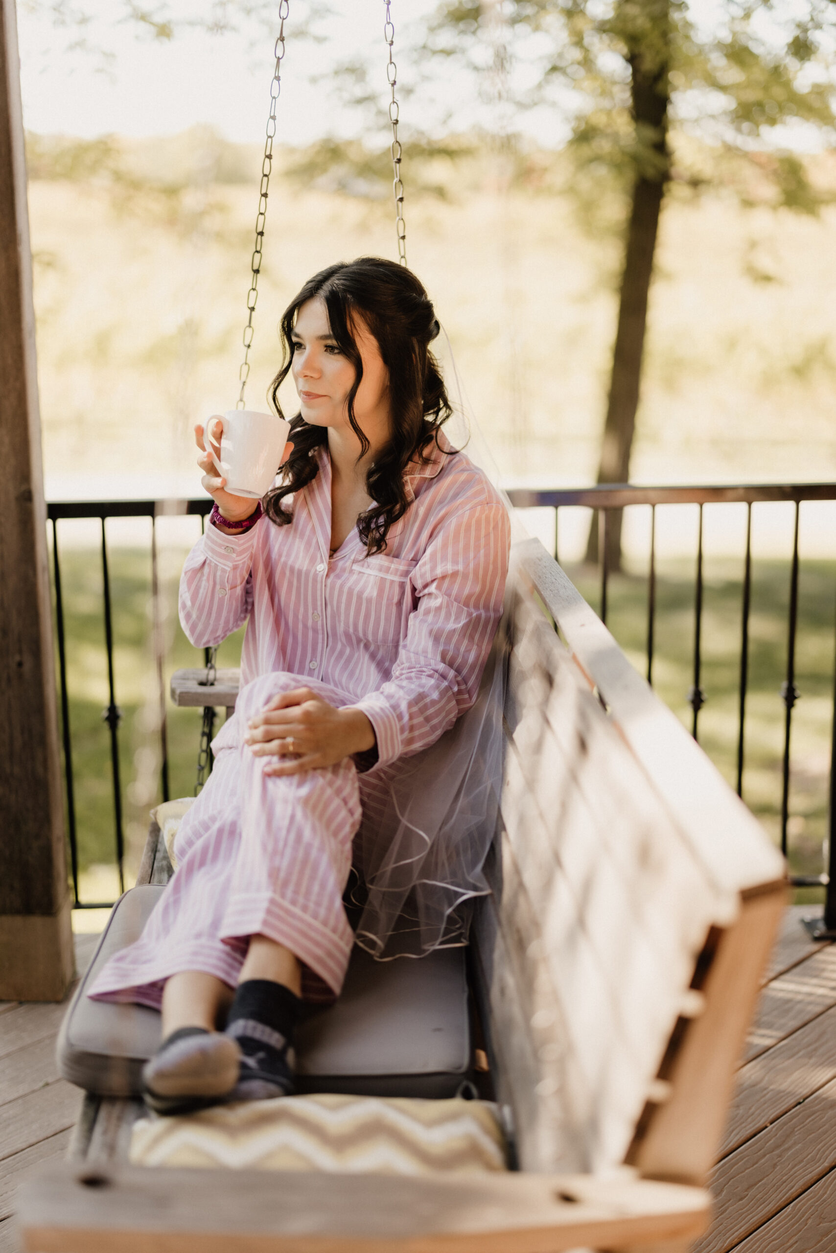 bride drinks coffee on porch swing cave spring estate house autu