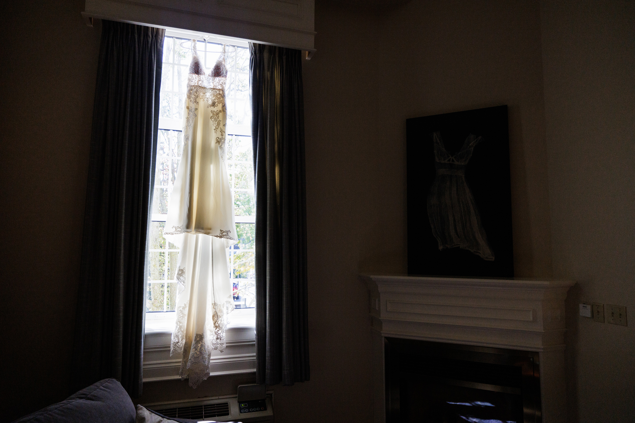 bridal gown hanging in window inn on the twenty