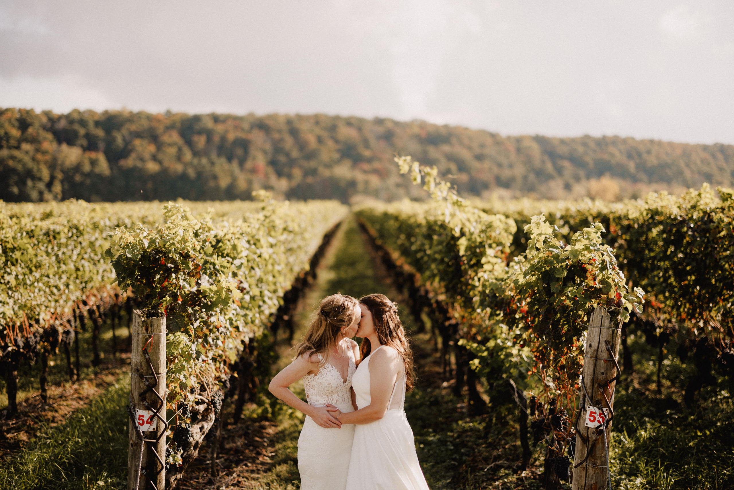 two brides romantic kiss cave spring vineyard wedding fall